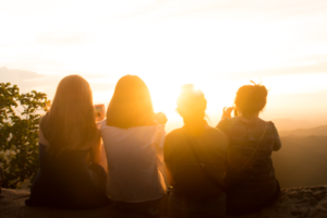 photo of 4 women facing the sunrise